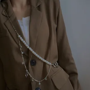 Details of double layer pearl waist chain with heart pendant, stylish body chain accessory.