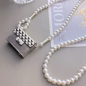 Mini bolso cruzado acolchado metálico con elegante accesorio de cadena de cintura de perlas.