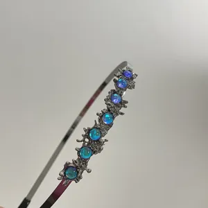Cerchietto in metallo stile punk con texture lavica e pietre di luna iridescenti blu.