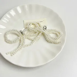 Pearl bow shoe clip accessory, elegant beaded footwear decoration for women's stylish shoes.