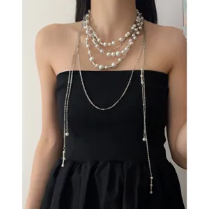Close-up detail of the vintage multi-layer beaded pearl tassel necklace with silver chains.