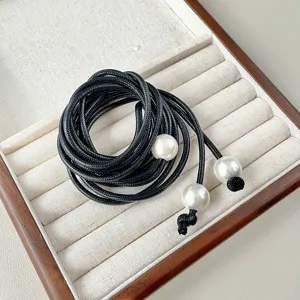 Black braided rope waist chain with elegant faux pearls, minimalist design for stylish women.