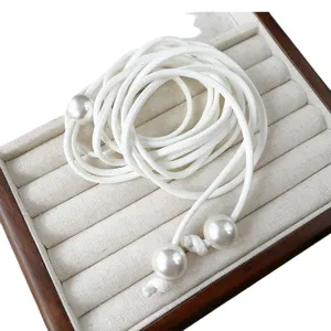 White braided leather rope waist chain with faux pearls, elegant adjustable accessory for women.