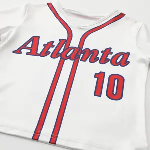 Kids cheerleading costume detail view, white baseball jersey with red and blue piping.