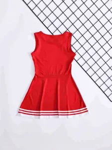 Red children cheerleader dress detail featuring sleeveless top and pleated skirt with white stripes.