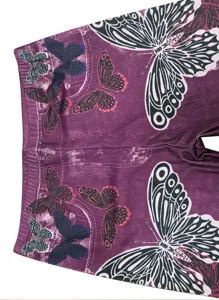 Primer plano detallado de leggings de imitación mezclilla morada para mujer con patrón de mariposa.