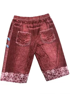 Detailed view of women's stylish red stretch denim print high waist shorts with lace hem.