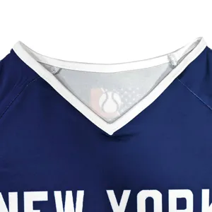 Close up detail of kids cheerleading uniform V neck dark blue sports top with letter print.