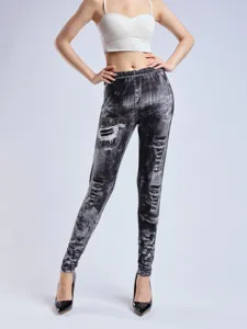 Close-up detail showing the digital print and ripped texture of the high-waisted stretch denim leggings.