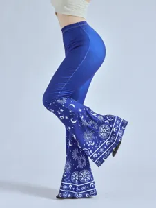 Detail shot of blue high waisted flare pants with celestial sun moon star print design.