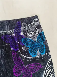 Close-up detail of women fashion butterfly print yoga leggings high waist elastic pants.