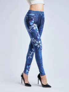 Women's high waisted stretch leggings with blue denim print, butterfly and flower patterns.