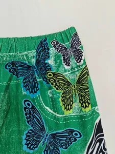 Butterfly print detail of high waist stretch yoga leggings, close-up view of the green pants.