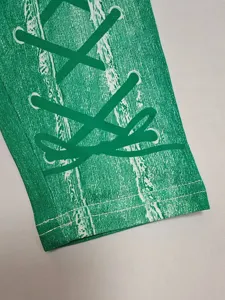 Green fashion fitness leggings pants detail view, stretch athletic pants close up show.