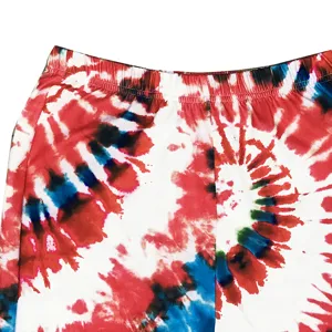 High waist tie-dye flare pants detail view, vibrant red and blue pattern, elastic waistband.