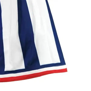 Detail view of girls cheerleading skirt with blue and white stripes and red hem trim.