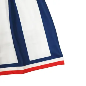 Close-up detail of children performance costume skirt hem featuring blue and red stripes design.