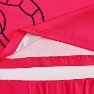 Close-up view of the vibrant pink cheerleader uniform fabric showing fine stitching and print details.