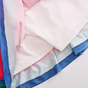 Close-up of children cheerleading uniform fabric showing neat blue stitching and soft lining details.