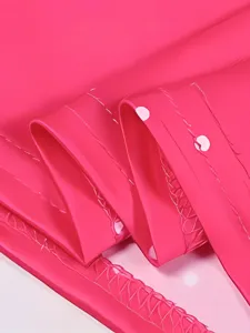 Bright pink dancewear fabric detail close up showing stretch material texture and fine stitching.