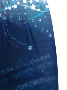 Close-up detail of women's blue star print faux denim leggings elastic fabric texture.