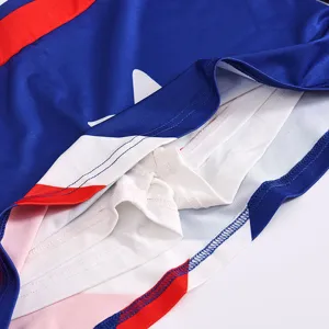 Kids cheerleading skirt detail view, blue red white colorblock activewear for school sports.