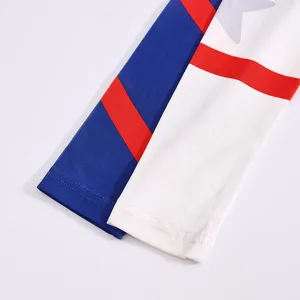 Close-up detail of children cheerleading costume sleeve with red blue stripes and star pattern.
