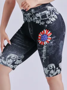 Detailed view of women's high-waisted slim printed denim style shorts with floral patterns.
