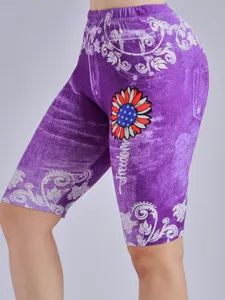 Close-up detail of purple floral printed high-waisted biker shorts with sunflower graphic.