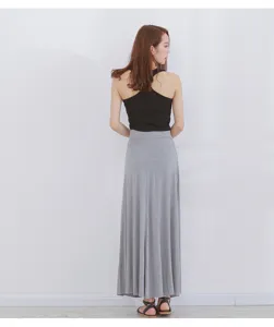Detailed view of women's high-waisted casual long A-line skirt in gray, showing drape and fit.
