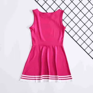Close-up detail view of the pink kids cheerleading dress skirt with white stripe hems.