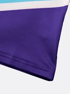 Close-up detail view of colorful children cheerleading costume fabric with neat double stitching.