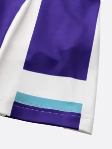 Close up view of kids cheerleading costume fabric, purple white color block and neat stitching.