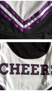 Cheerleader costume detail view showing black white fabric, purple ribbon trim and CHEERS print.