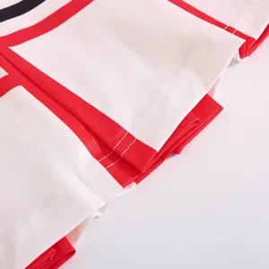 Children cheerleader skirt detail shot, red and white pleated fabric, cute athletic wear.