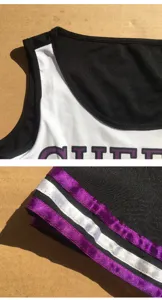 Women cheerleading uniform detail shot, black and white sports performance costume top