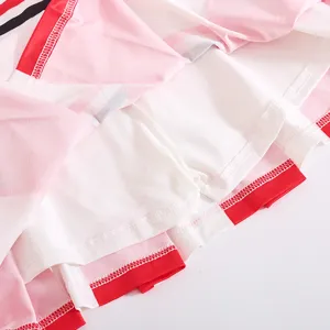 Close-up detail of children cheerleading costume pink red white stitching and inner lining shorts.