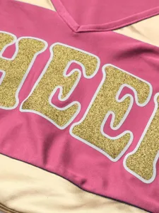 Cheerleading uniform top short sleeve V-neck pink gold glitter letters detail apparel