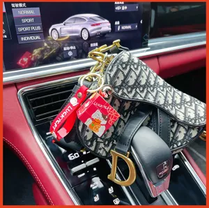 Mini lucky cat cube keychain with designer saddle bag pendant for car keys and backpacks style.