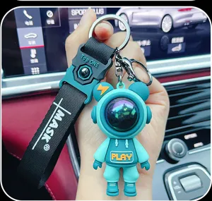 Trendy astronaut bear keychain with woven strap, cute epoxy resin pendant for car keys and bags.