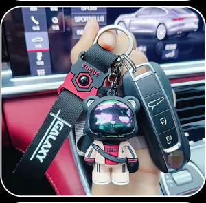 Trendy astronaut bear keychain with black strap, stylish metal and epoxy resin car key accessory.