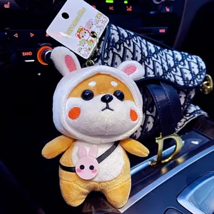 Cute Shiba Inu plush toy keychain with rabbit hood and bag charm, soft stuffed doll pendant.