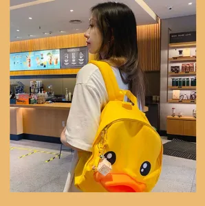Cute yellow duck school backpack with lovely mini shiba inu pendant, stylish and fun design.
