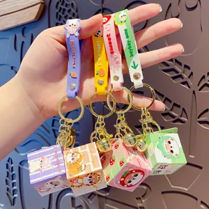 Cute cartoon rubik's cube keychain set with silicone strap, creative decompression toy pendant.