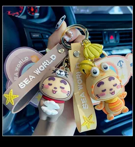 Close-up of cute cartoon ocean series keychain with silicone straps and star charms in car interior.