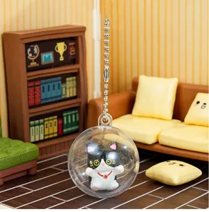 Detailed close-up of a cute 4cm capsule cat keychain doll displayed in a miniature dollhouse room.
