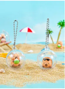 Cute capybara gashapon keychain detail, lovely cartoon toy pendant for bags and keys.