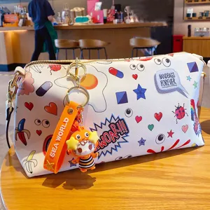 Cute cartoon ocean series canvas handbag with playful keychain pendant and vibrant prints.