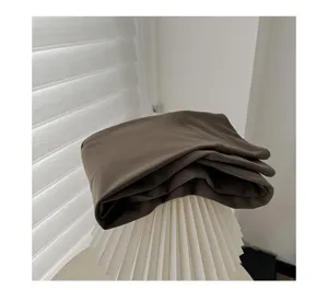 Detail shot of folded brown brushed winter women's tights showcasing soft fabric texture.
