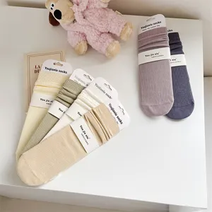 Comfortable solid color ribbed cotton women mid-tube socks with heel, cozy autumn wear.